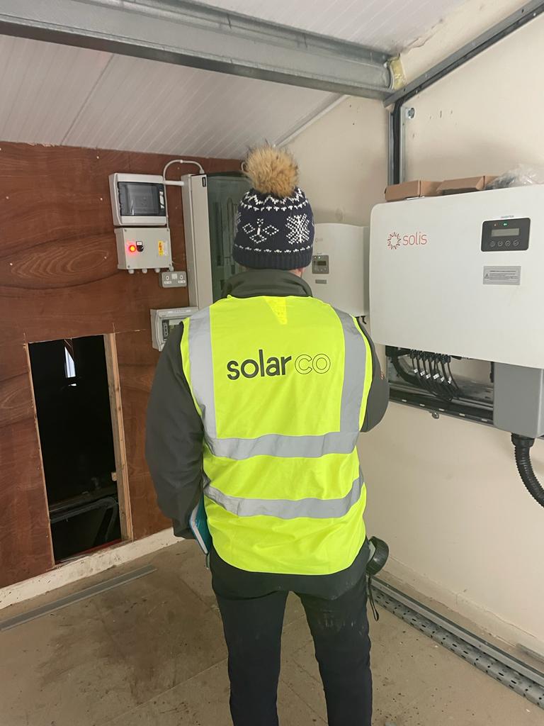 A Solar Project Manager overseeing the installation of solar panels on a commercial building, coordinating teams, timelines, and ensuring the project meets all safety and efficiency standards.