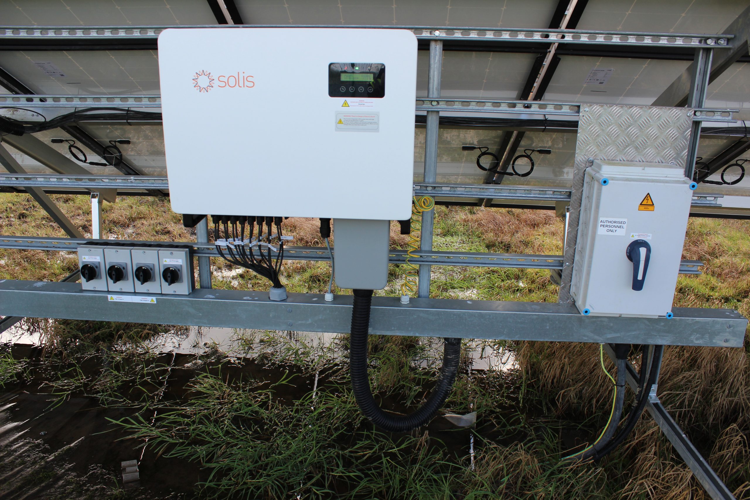 A solar PV inverter, converting the direct current (DC) electricity generated by solar panels into alternating current (AC) for use in a business